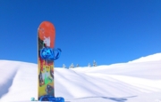 Image of a snowboard planted in the snow