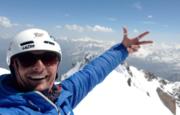 Image of a smiling ski instructor on a mountain top